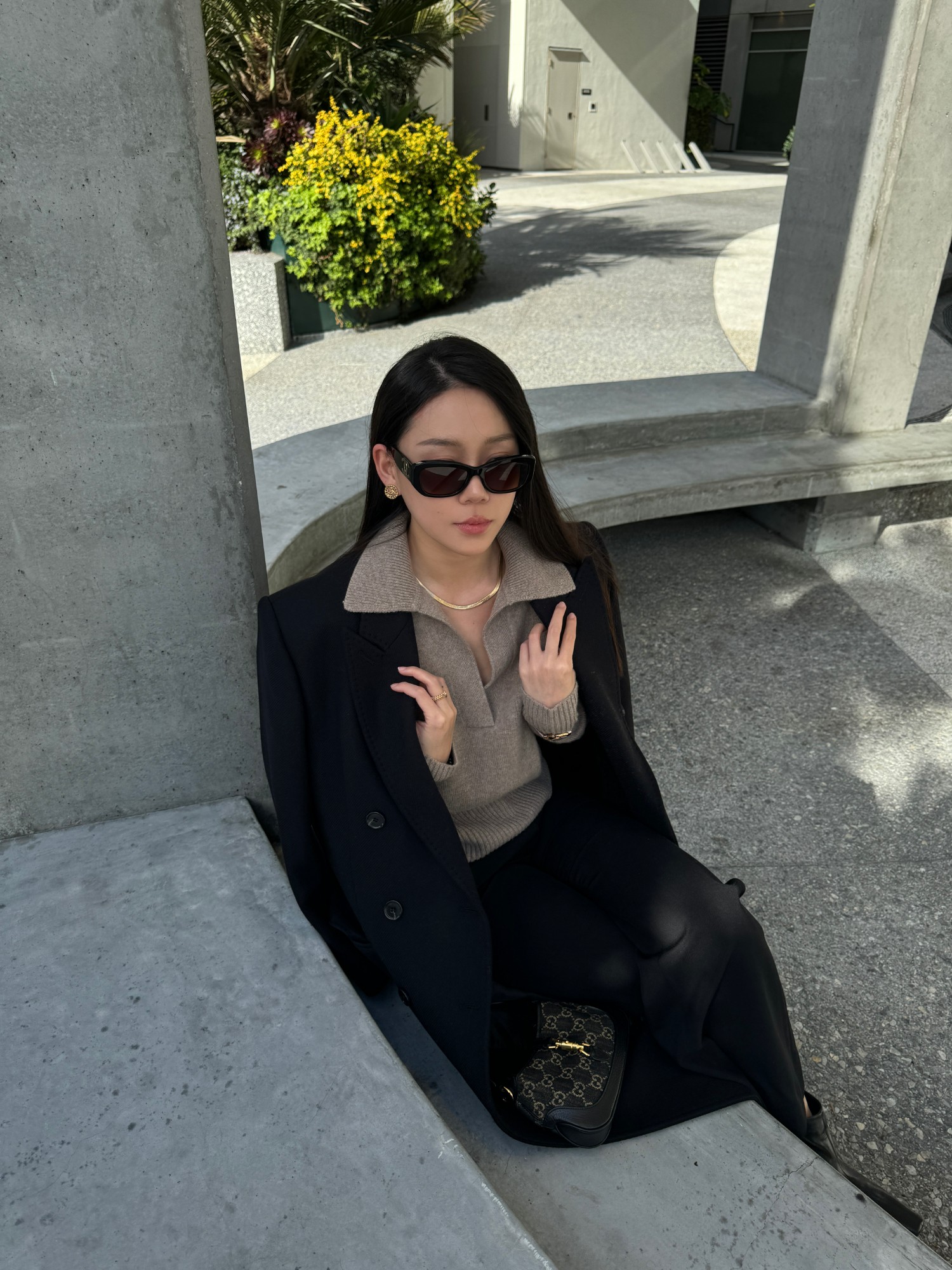 Cashmere polo collar sweater under a black coat in daylight
