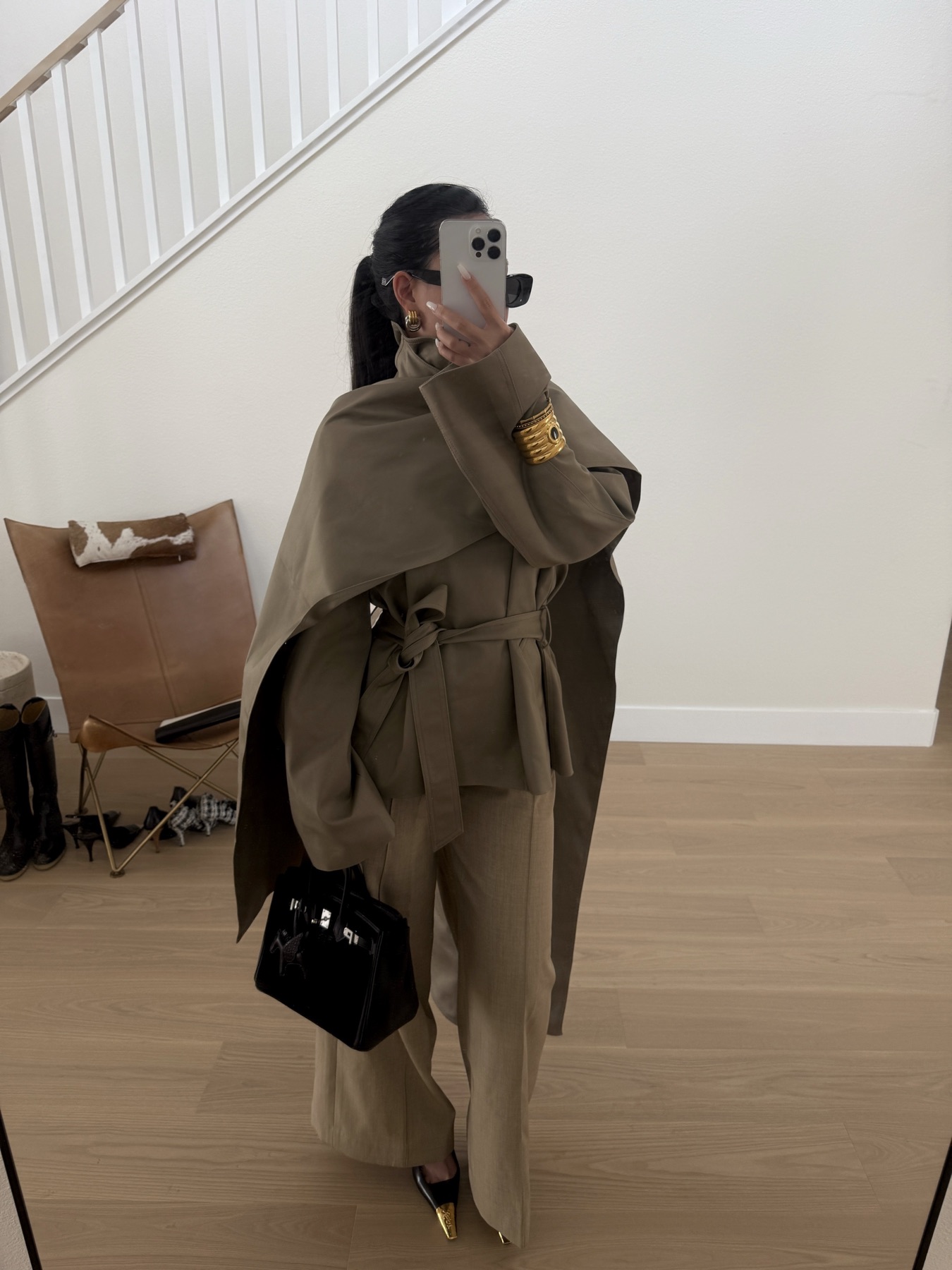 Close neutral trench styling with gold cuff detail