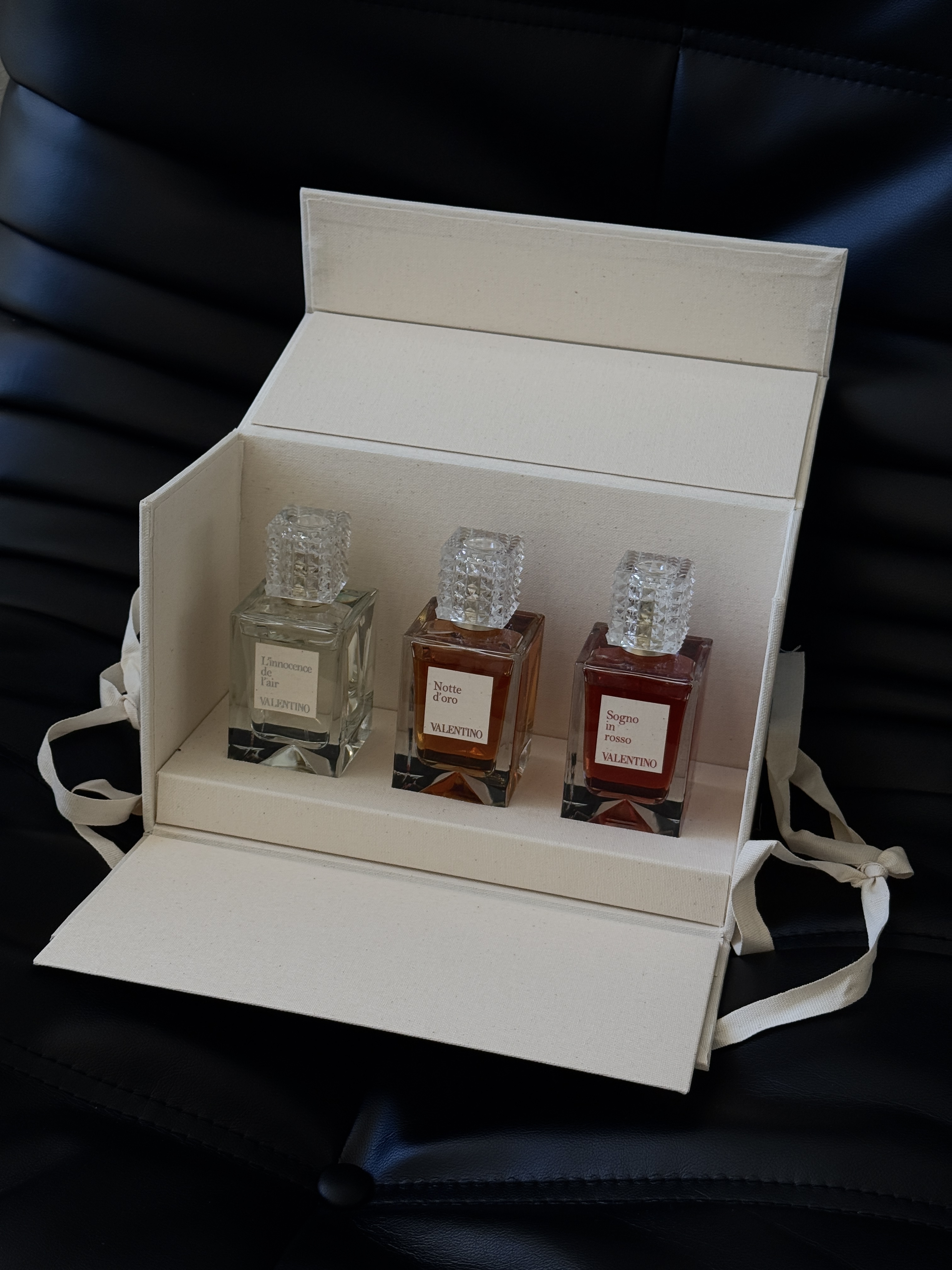 Valentino fragrance set in a cream box on black leather