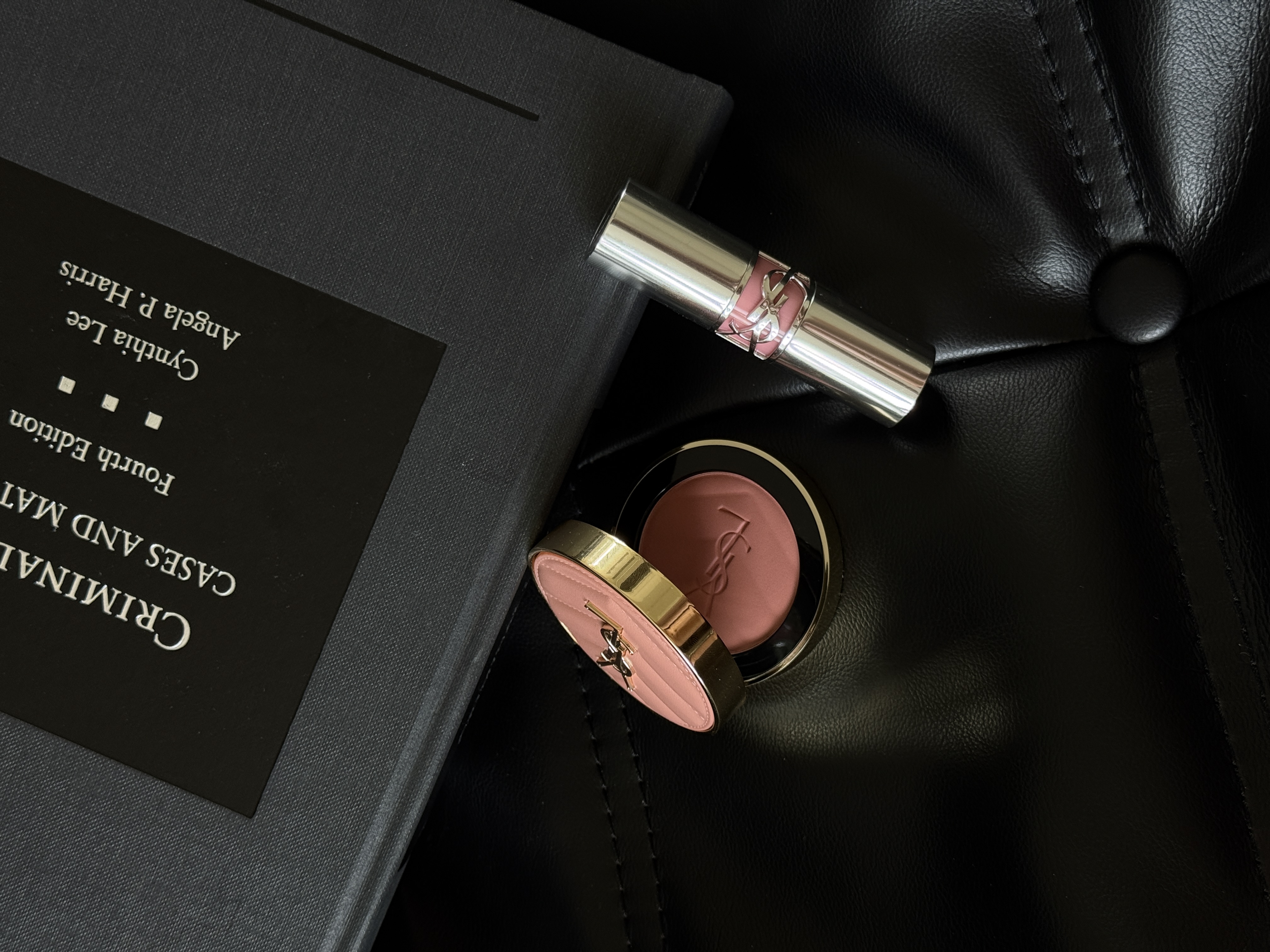 YSL Beauty makeup arranged on black leather