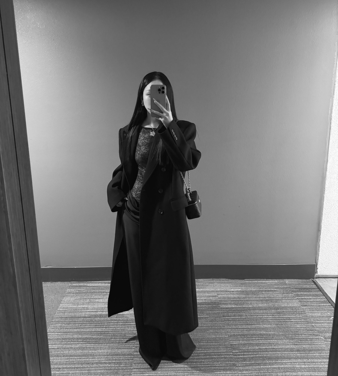 Cropped black satin dress study in a mirror reflection